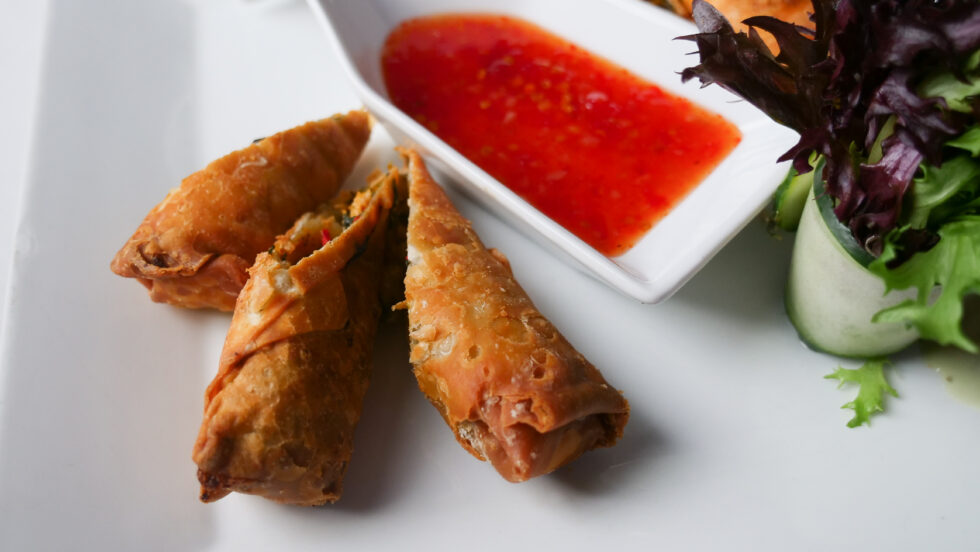 Jerk chicken egg rolls served with sweet chili sauce